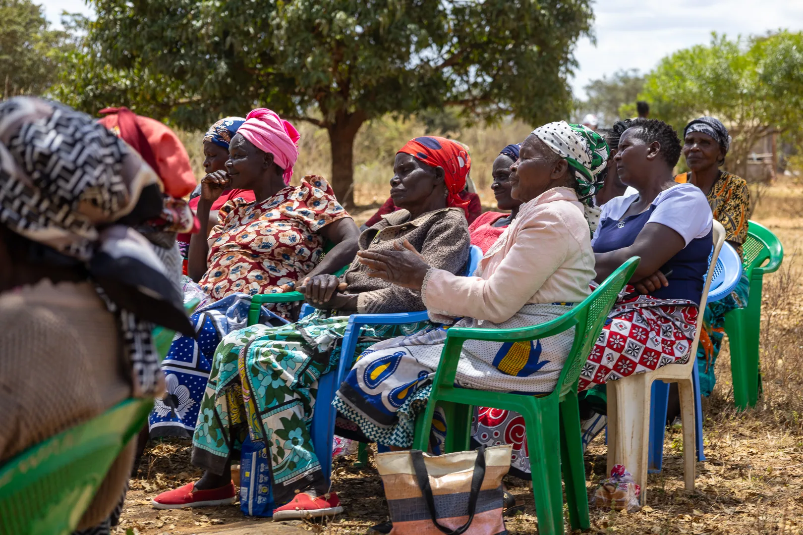 Women listening together at a community forum